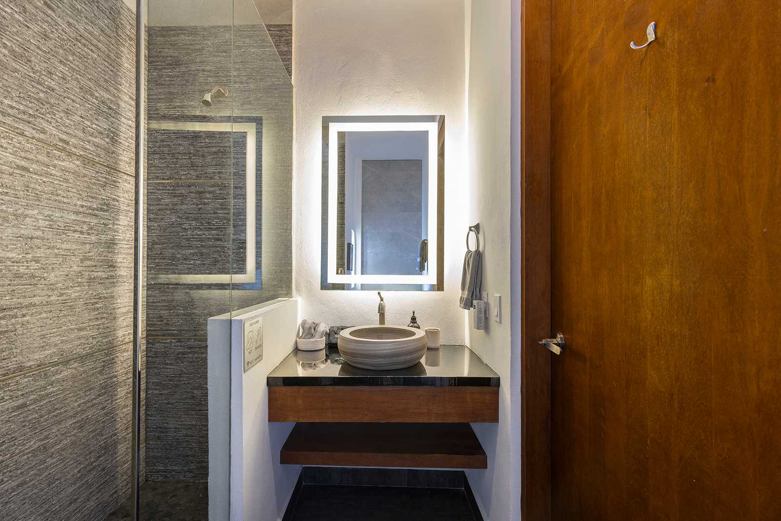Modern stone-finish luxury bathroom suite at Villa Hurakán in Akumal