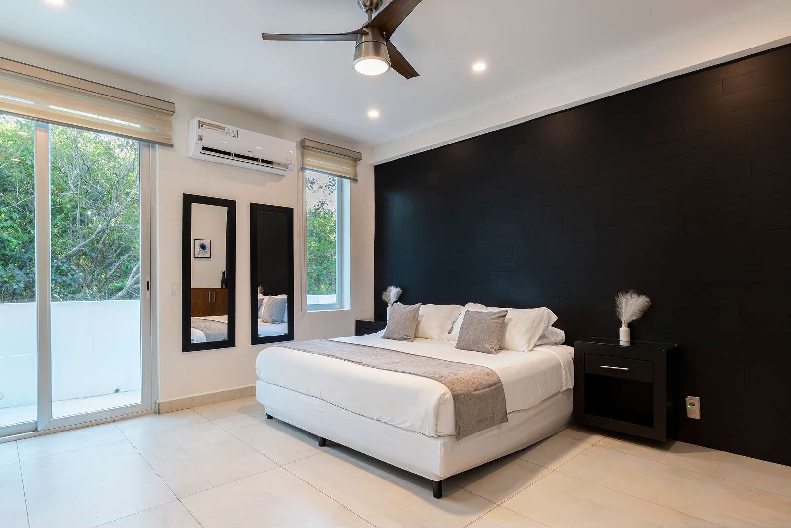 Modern luxury bedroom with dark accent wall at Villa Hurakán