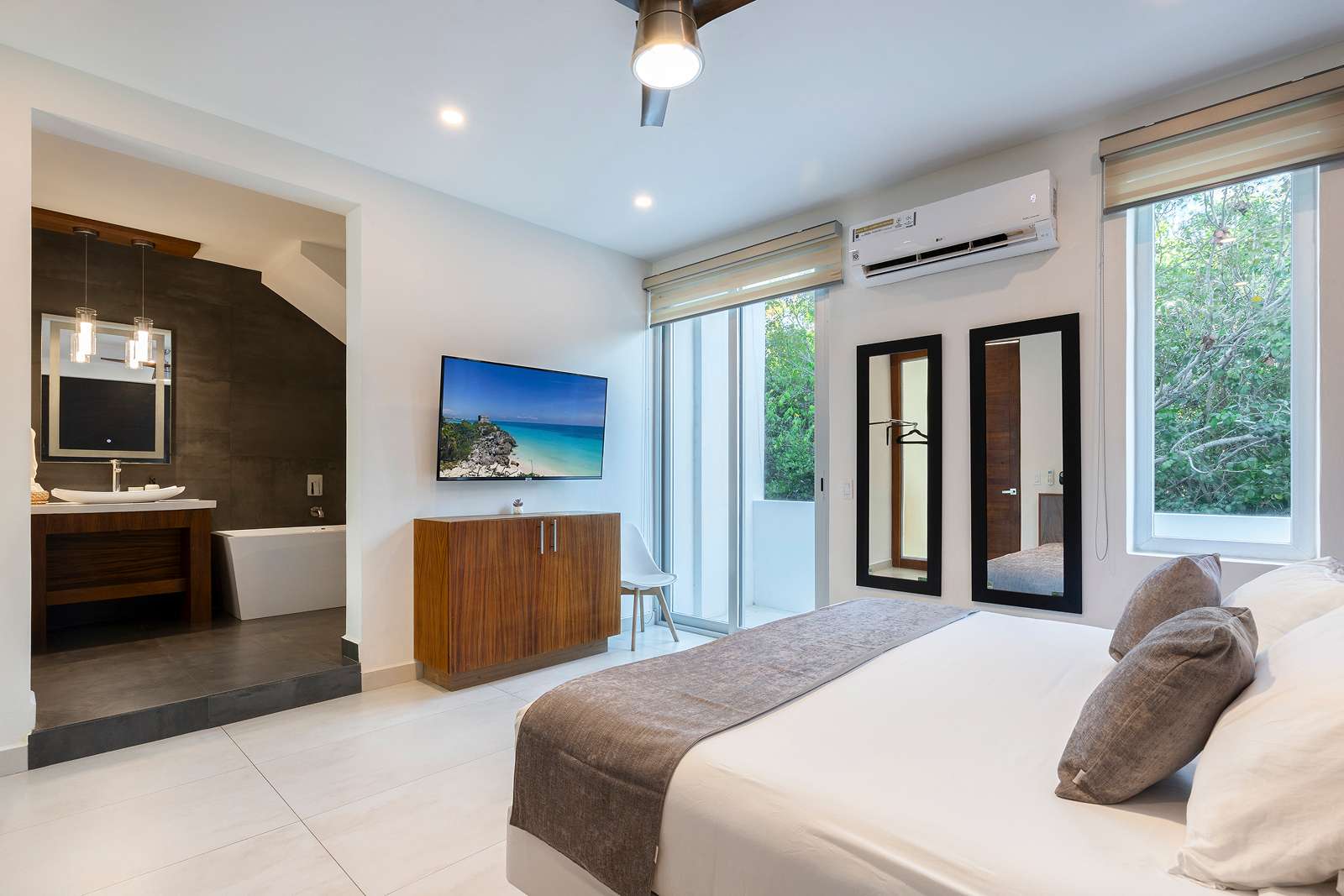 Spacious master bedroom suite with jungle views at Villa Hurakán
