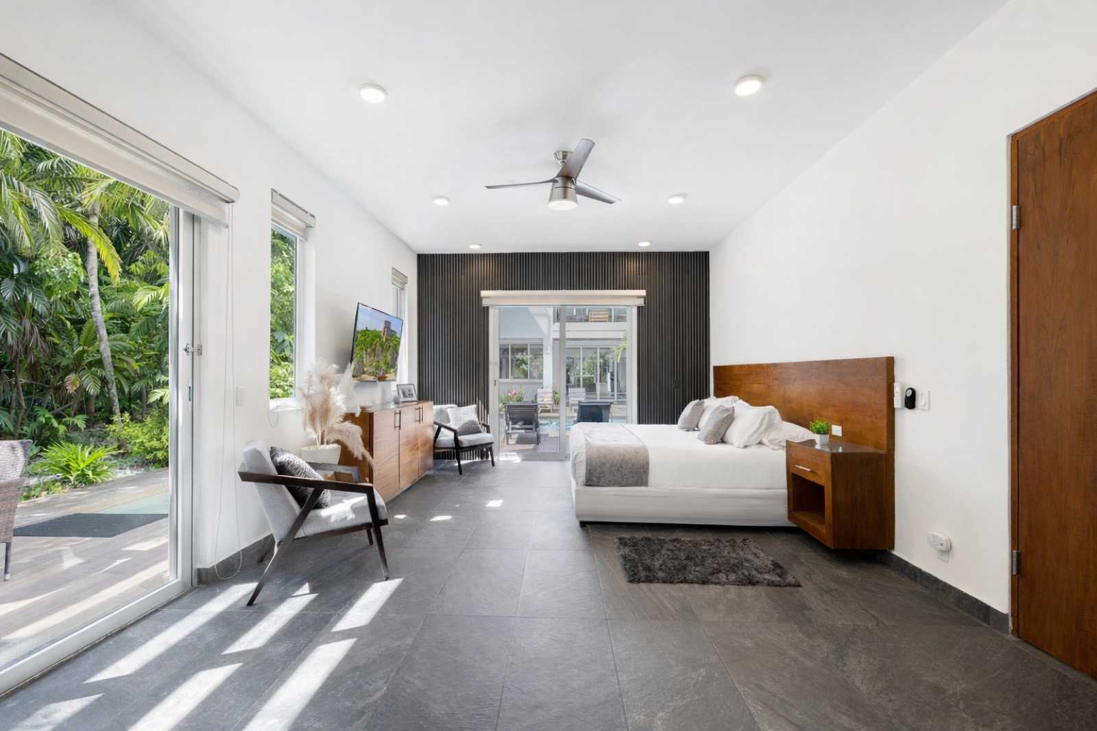 Spacious luxury master suite with natural light at Villa Hurakán