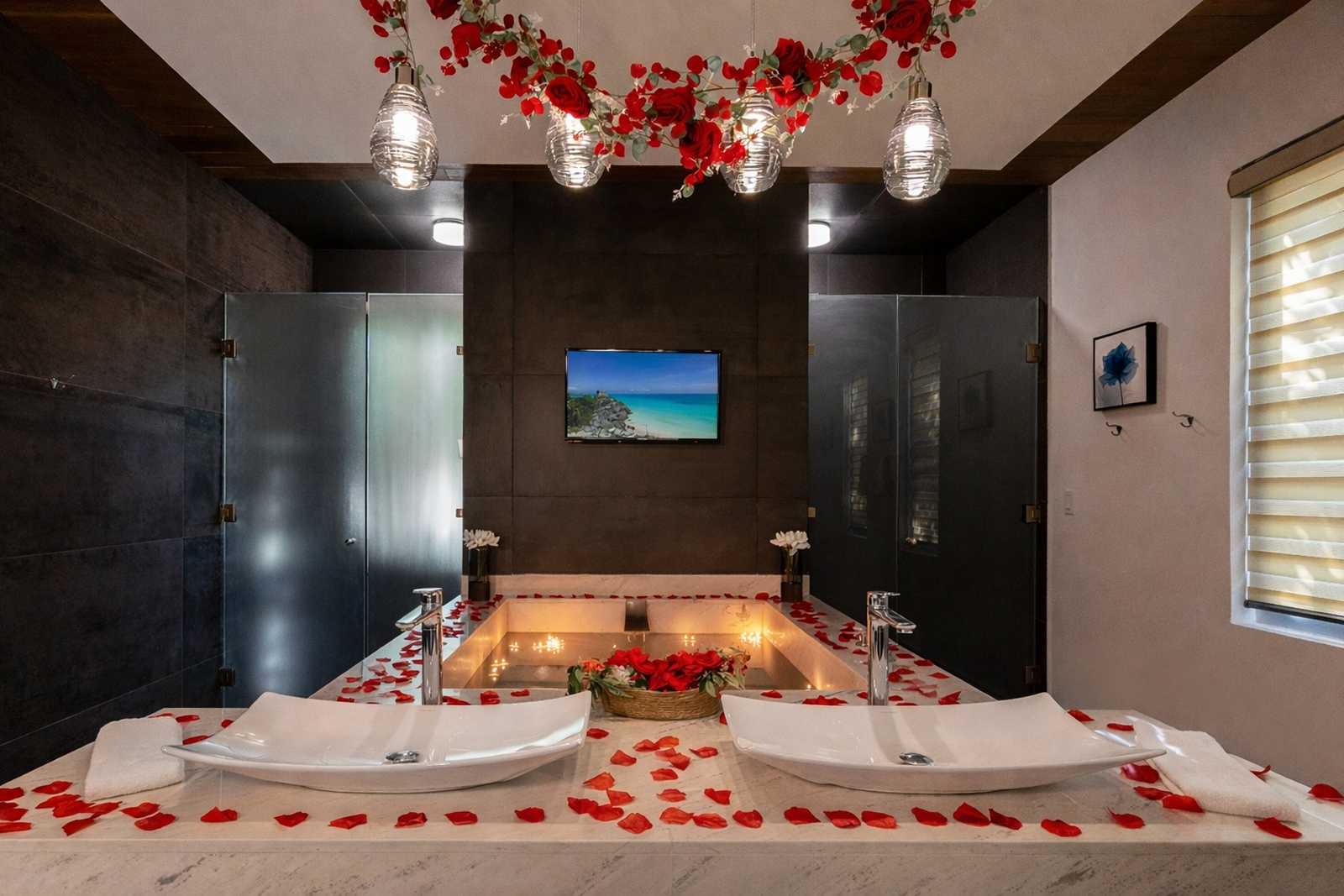 Luxury romantic bathroom suite with rose petal bathtub setup at Villa Hurakán