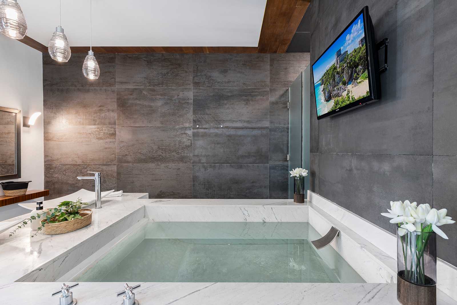 Modern spa-style bathroom with soaking tub inside Villa Hurakán