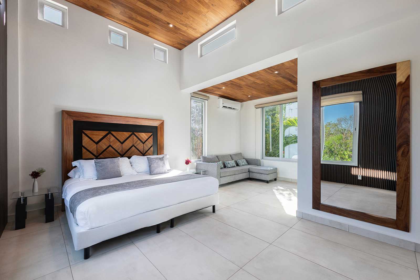 Luxury master bedroom suite with wood ceiling accents at Villa Hurakán