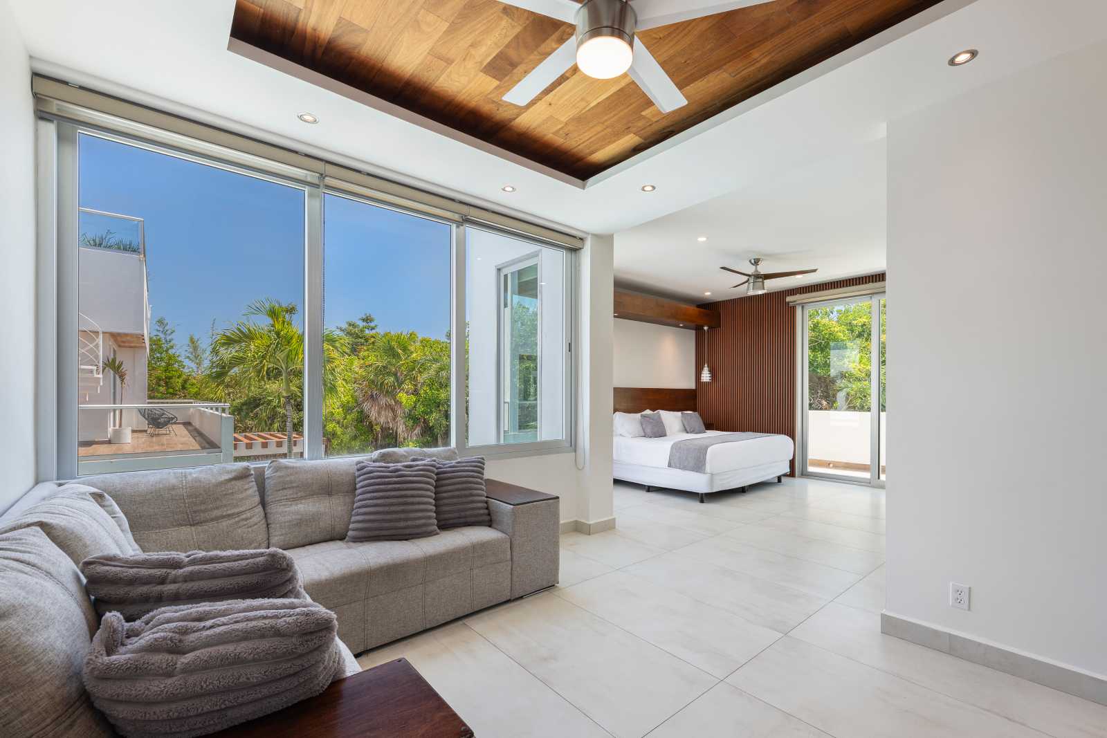 Luxury bedroom and lounge layout with natural sunlight at Villa Hurakán