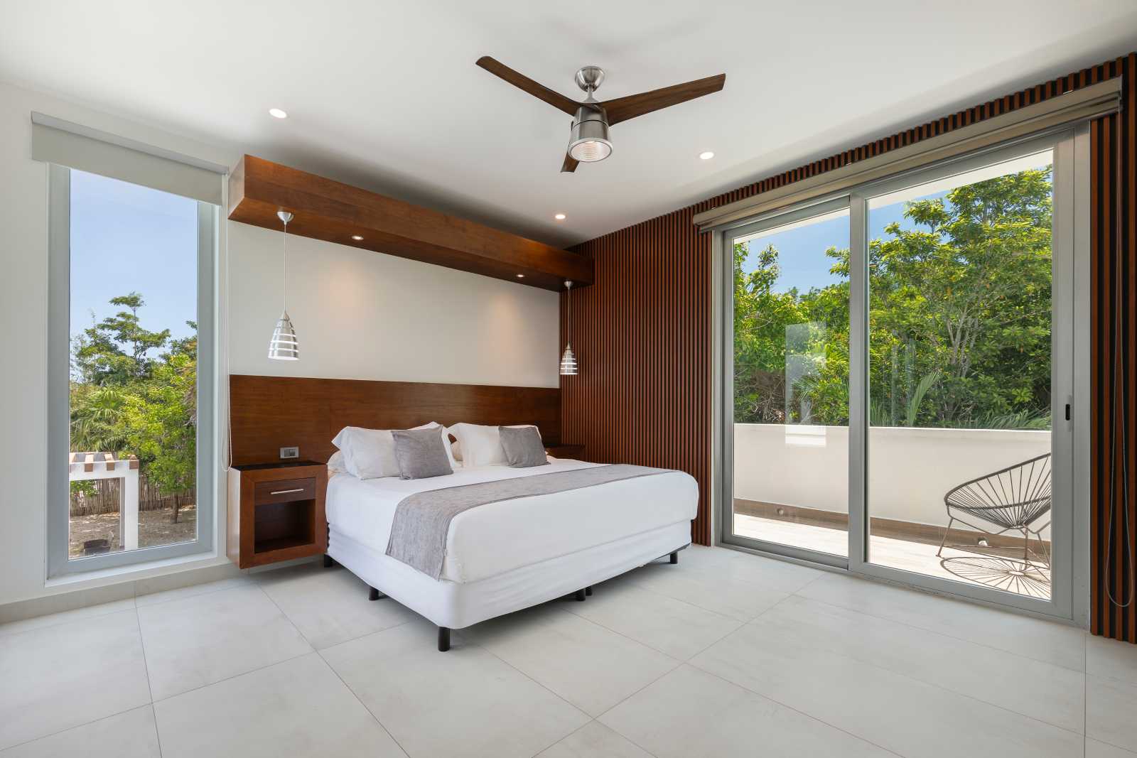 Luxury bedroom with floor-to-ceiling windows at Villa Hurakán