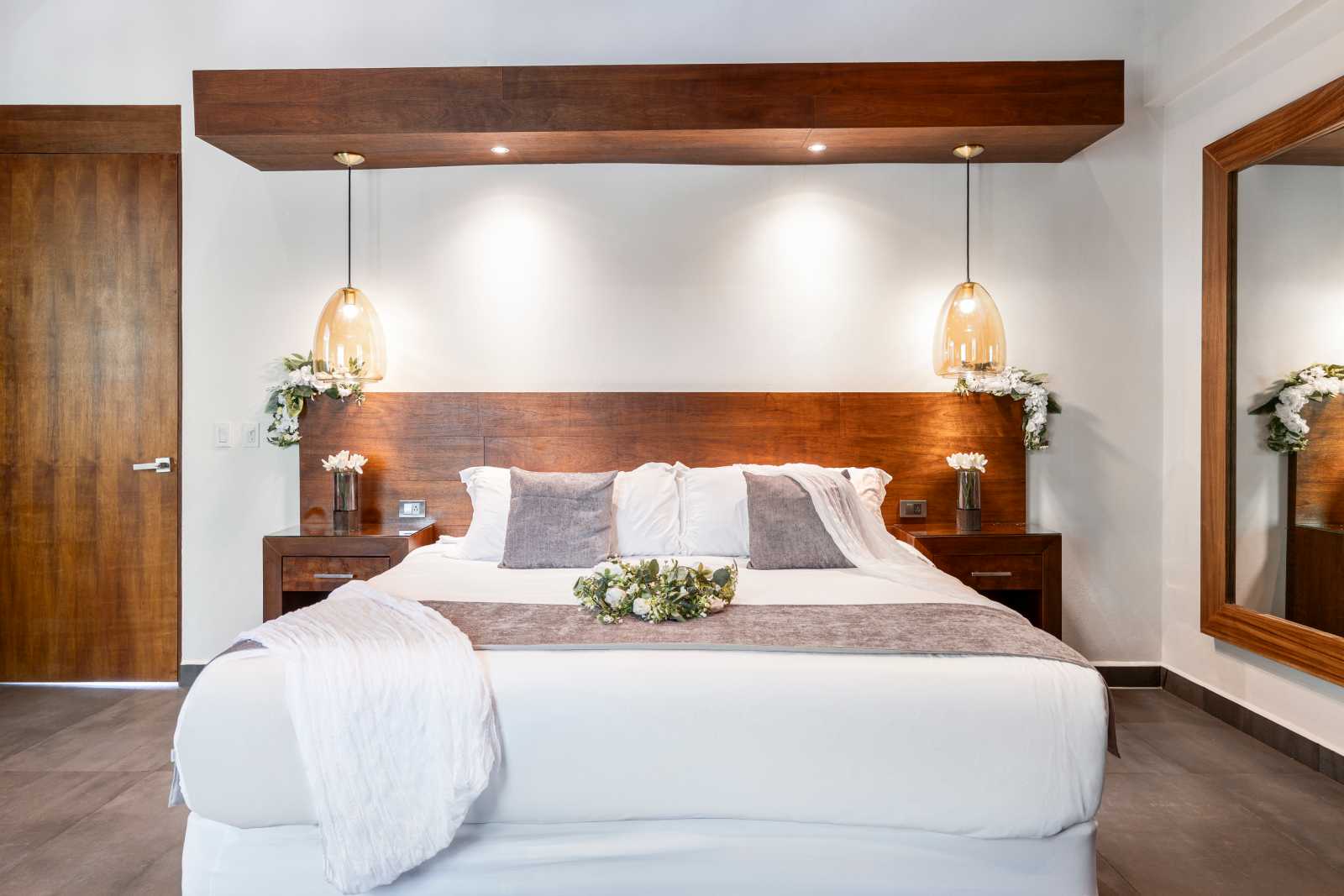 Elegant king bedroom suite with modern lighting at Villa Hurakán