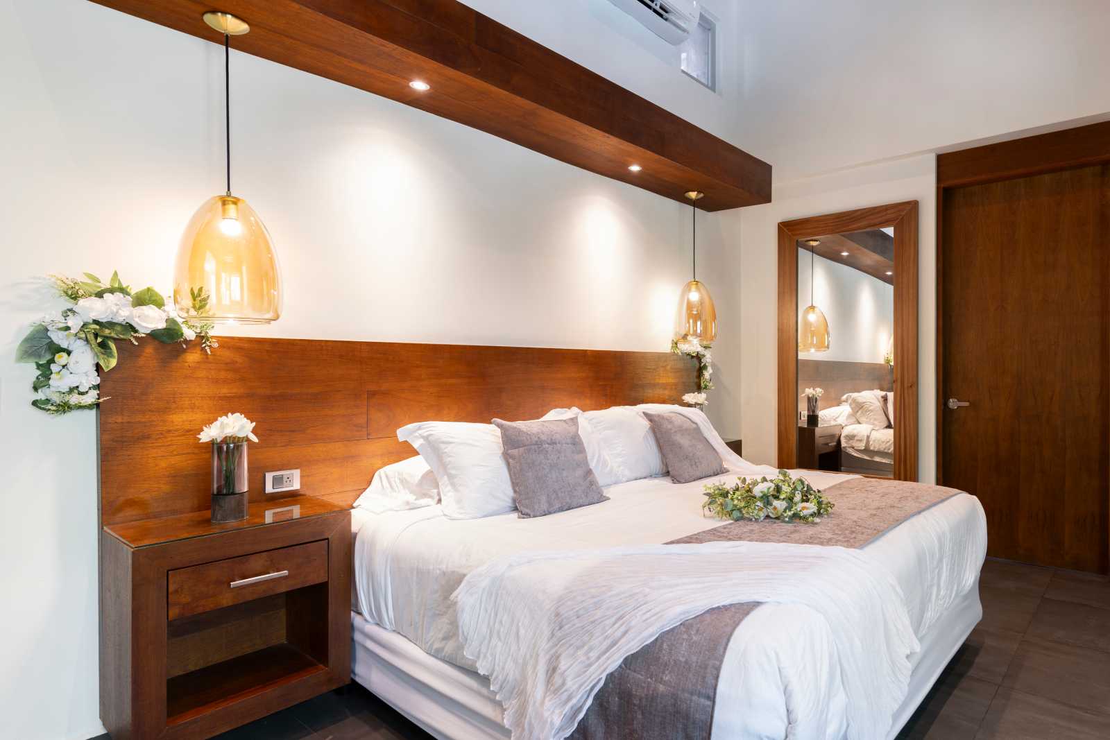 Luxury master bedroom with wood-accent interior at Villa Hurakán