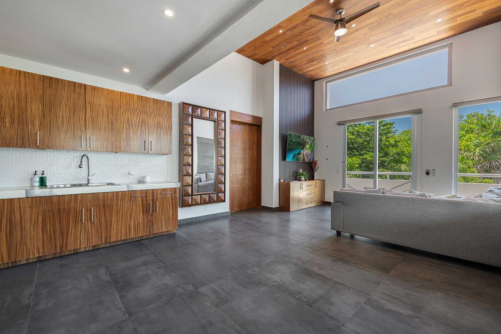 Open-concept luxury suite with kitchen and seating area at Villa Hurakán