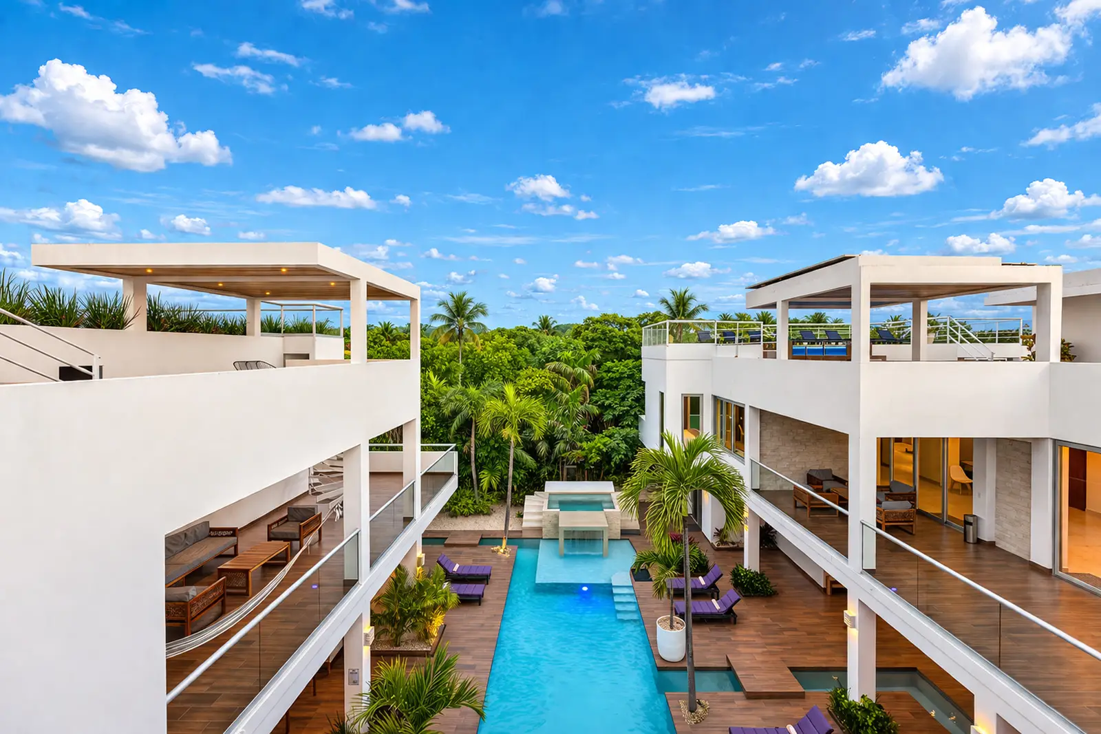 Main pool courtyard with elevated ocean-facing terraces at Villa Hurakán