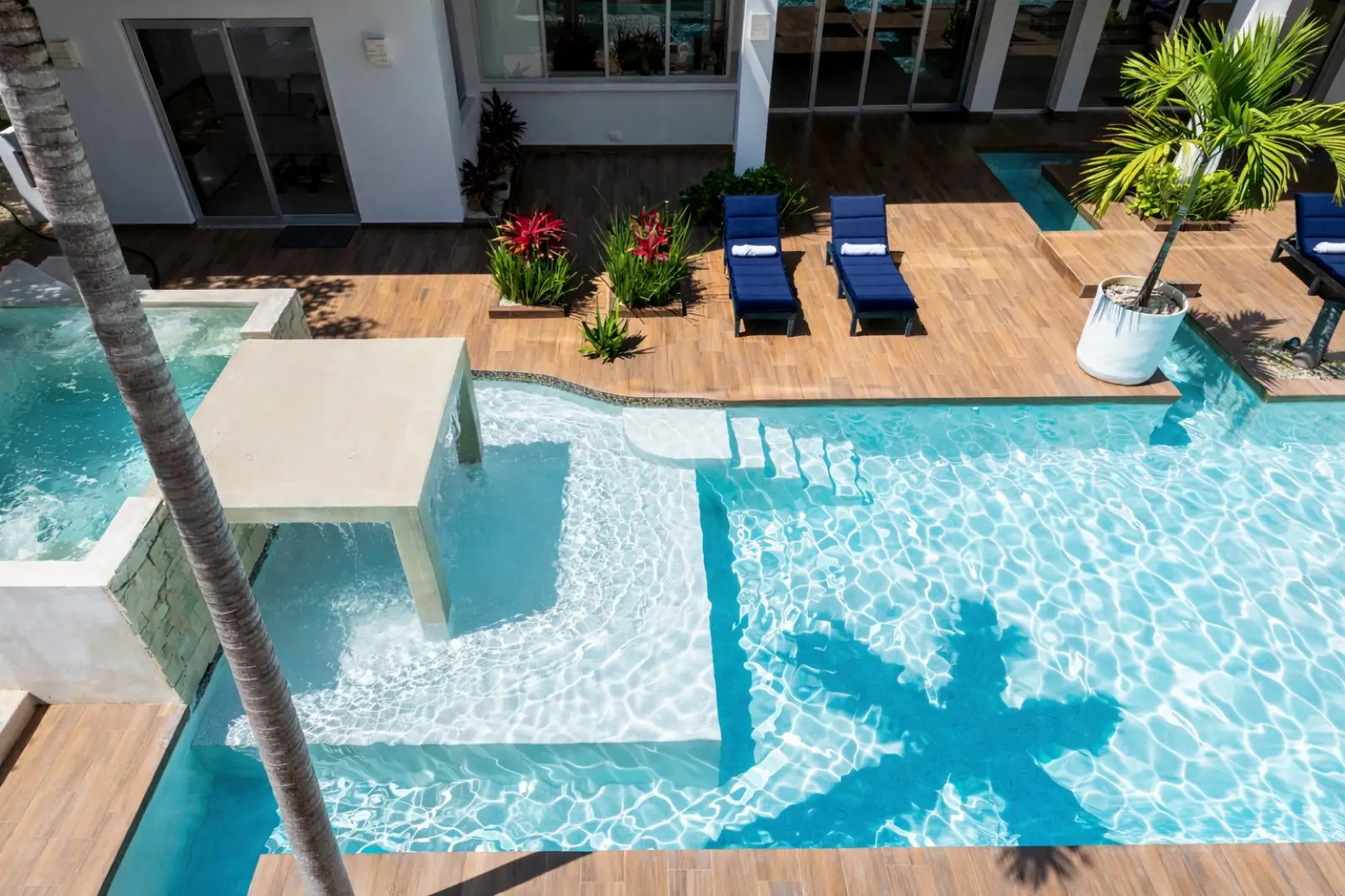 Luxury pool jacuzzi and sun lounge area at Villa Hurakán