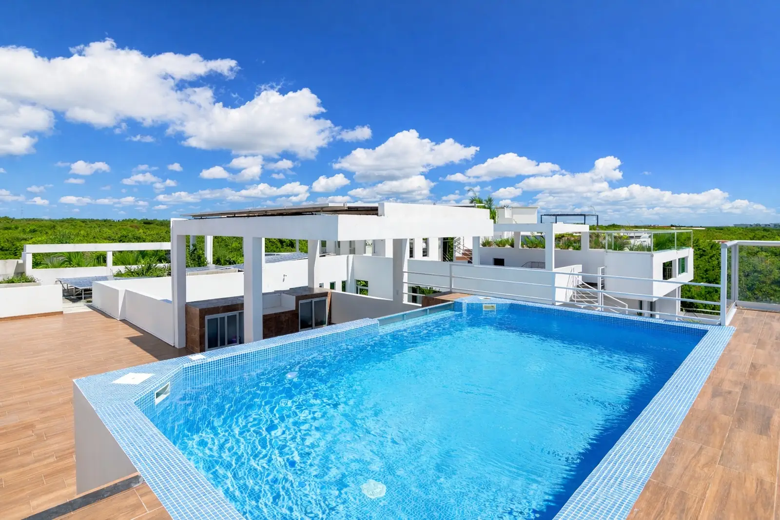 Luxury rooftop infinity pool with panoramic sky views at Villa Hurakán
