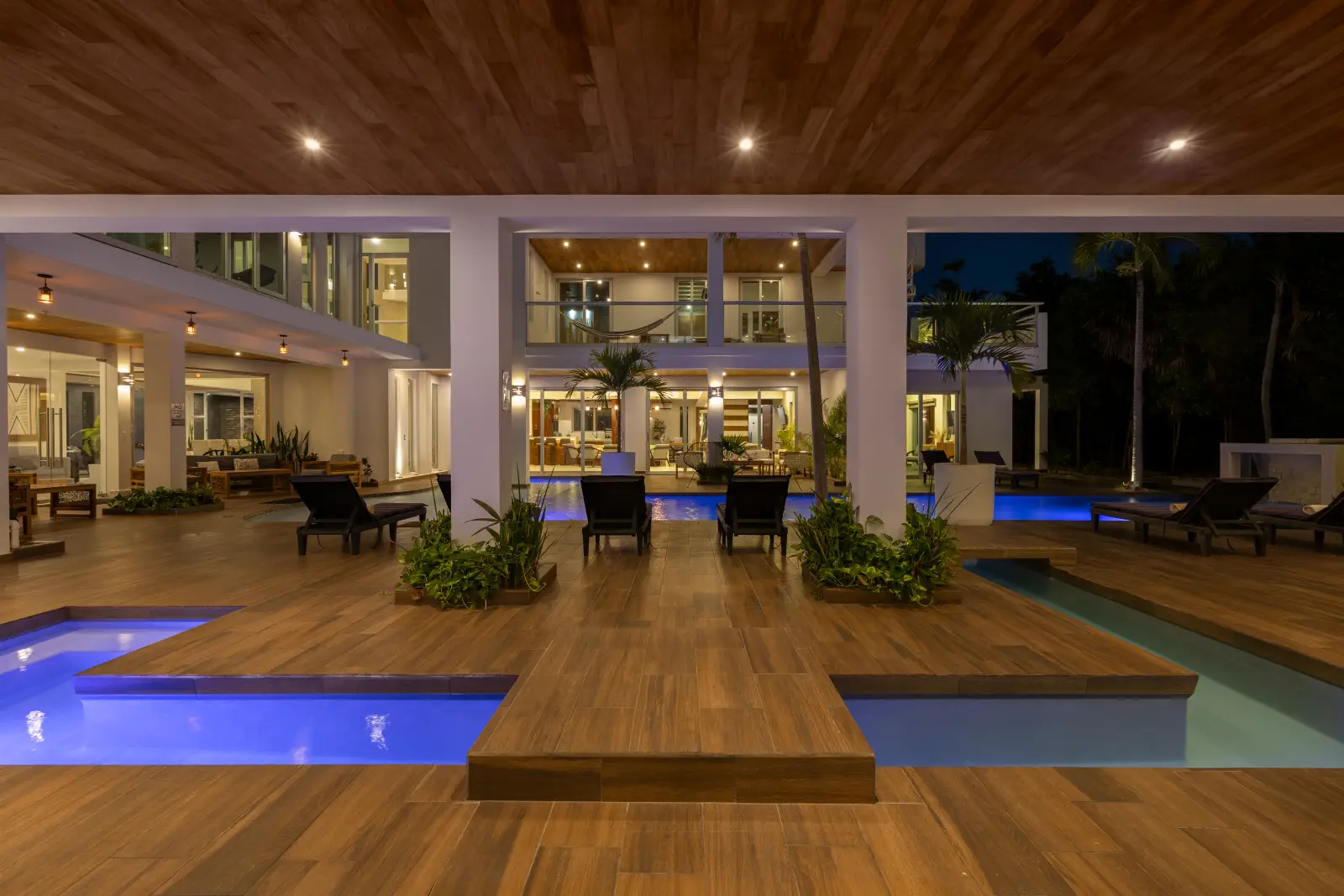 Luxury nighttime pool lounge area at Villa Hurakán in Akumal Riviera Maya
