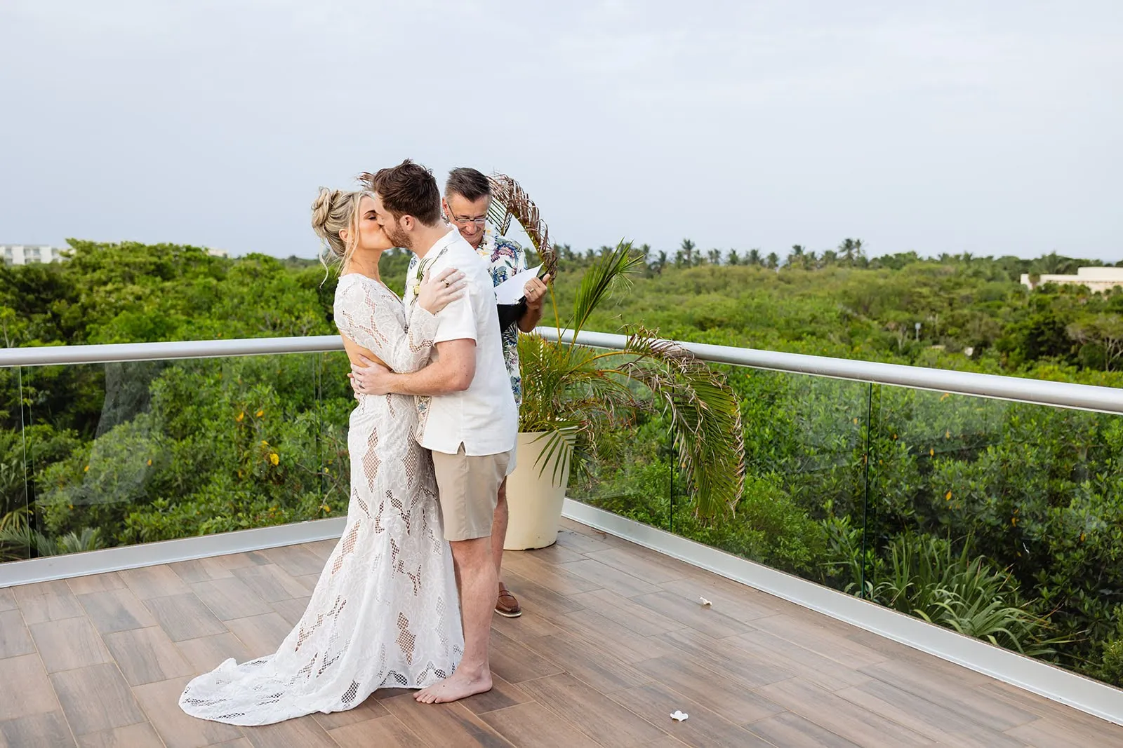 Bride and groom portrait on rooftop terrace overlooking the jungle in Riviera Maya