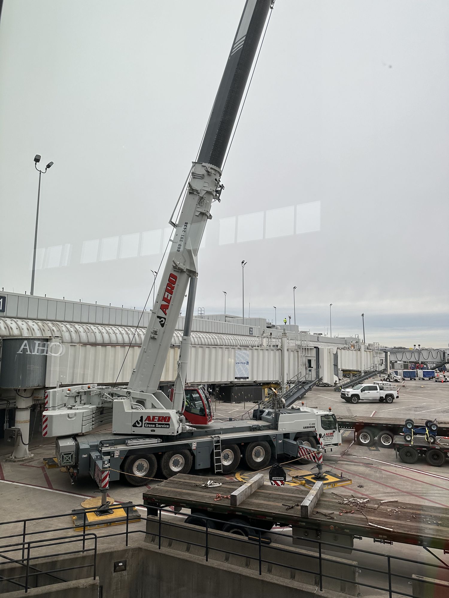 Aero Crane Service performing airport tarmac equipment lift