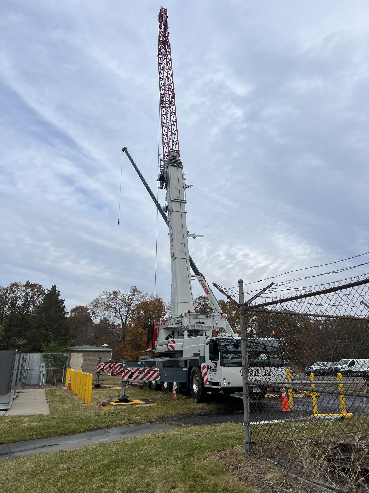 Aero lattice-boom crane working at utility site