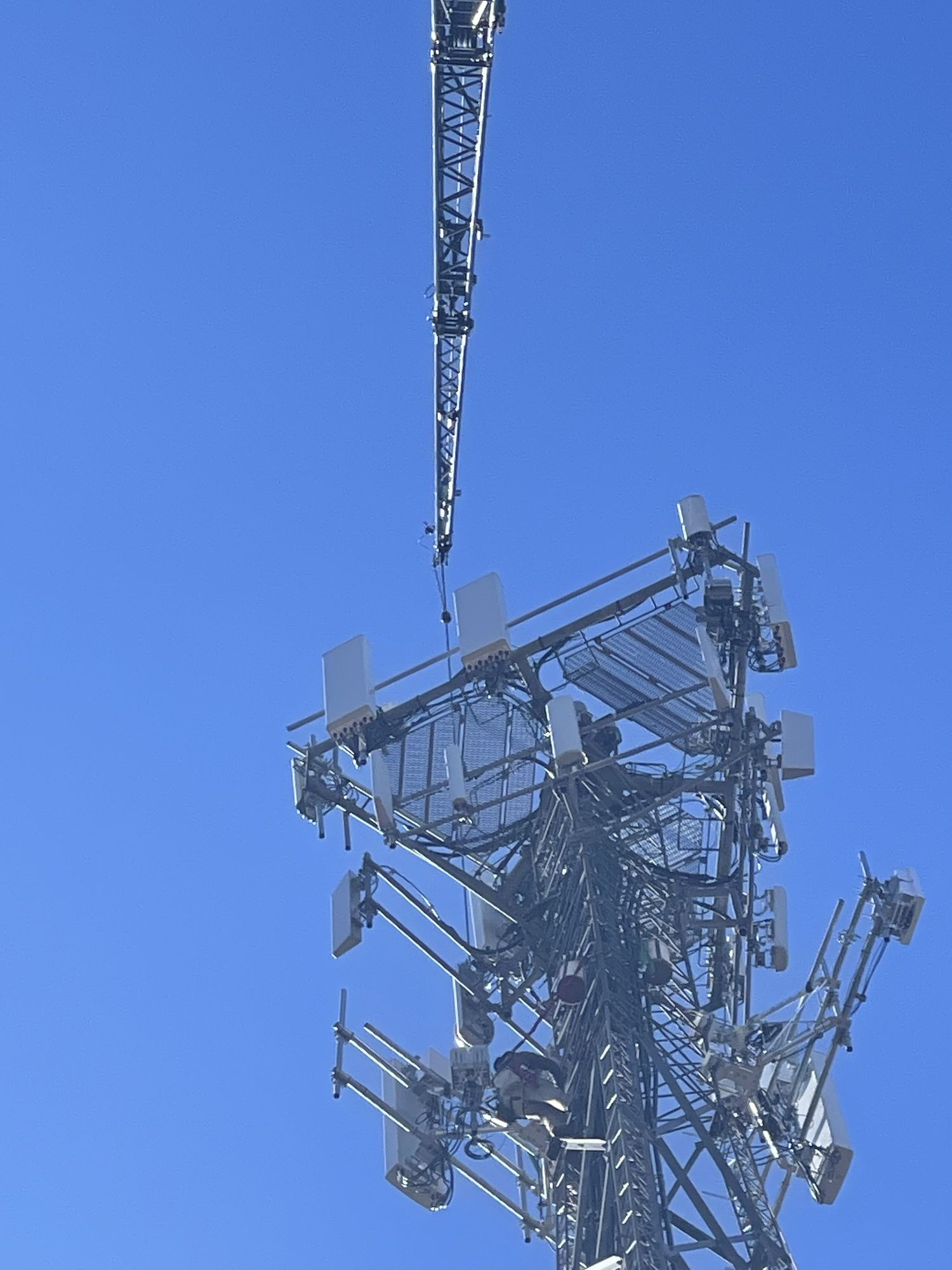Aero Crane lifting cell tower section during telecom installation
