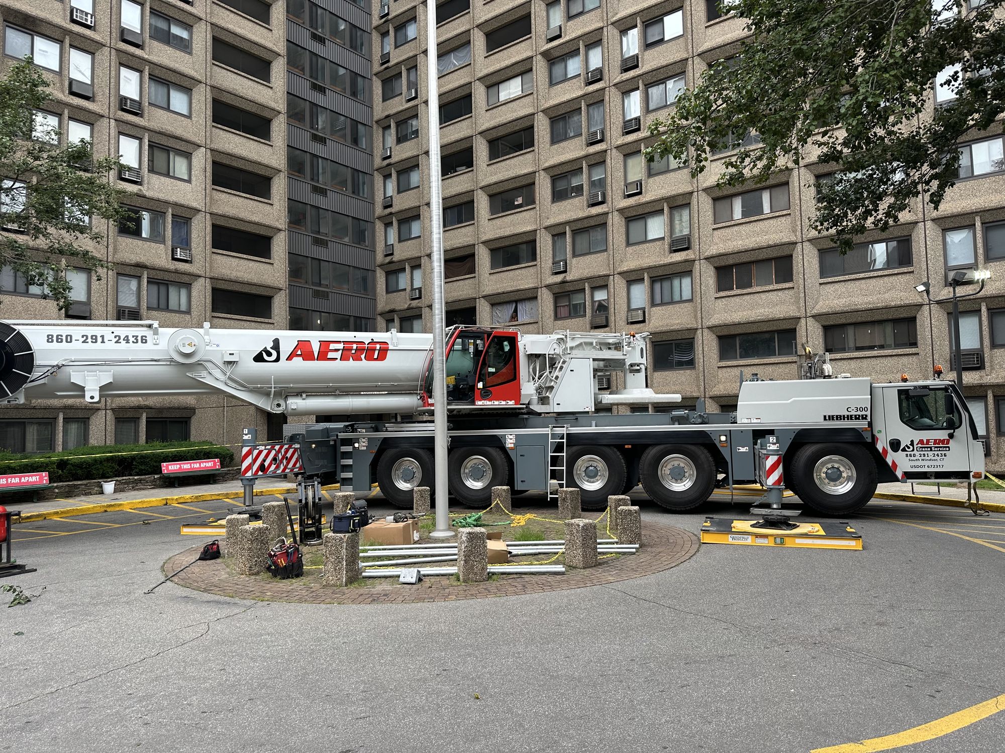 Crane boom extended over historic church for cupola removal
