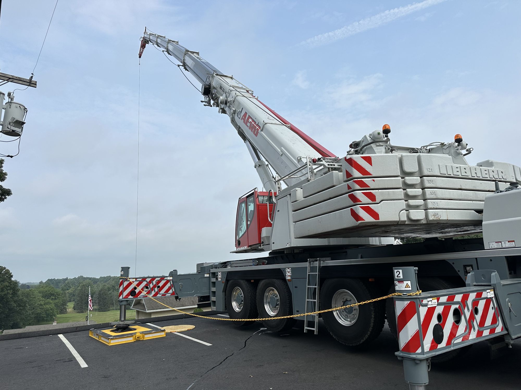 Outrigger pads positioned in church parking lot for crane lift