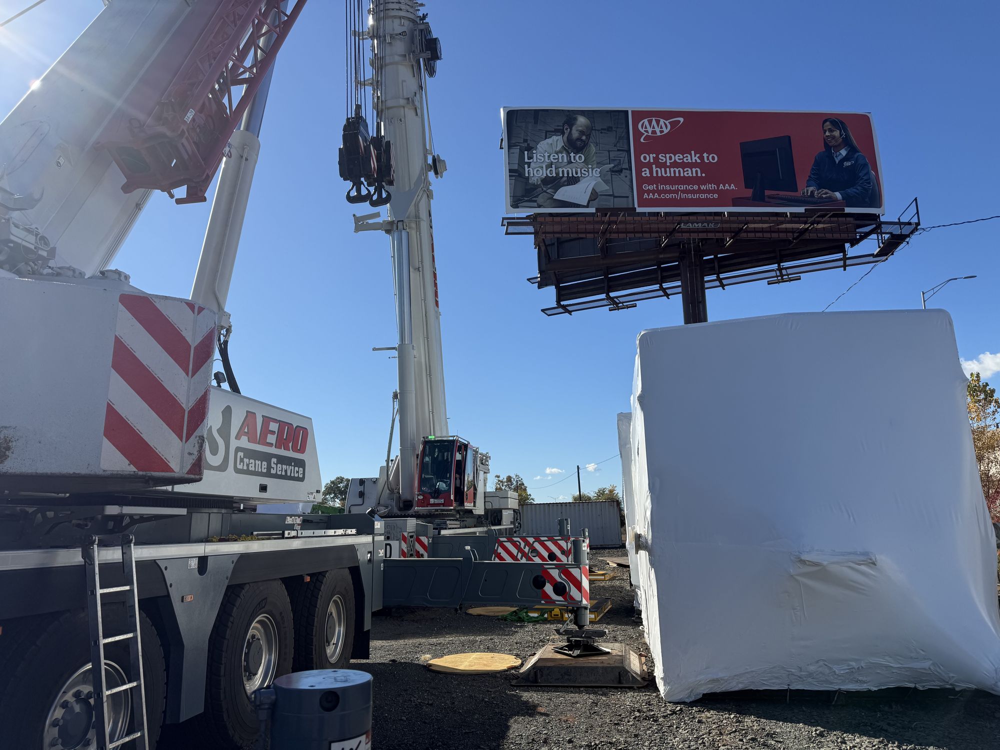 Highway sign placement by Aero operated crane
