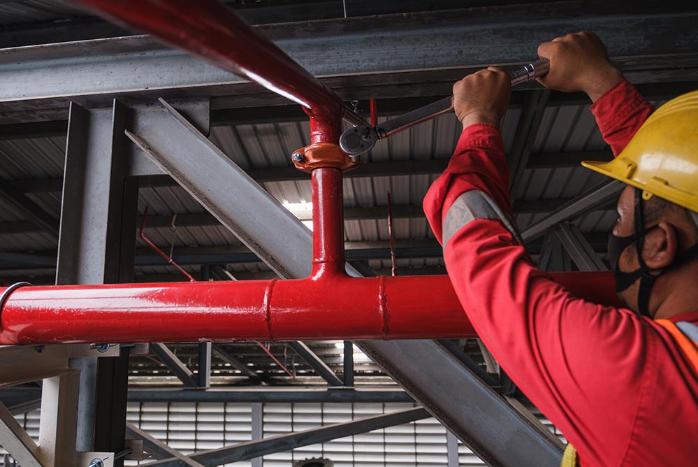 a person installing a sprinkler system