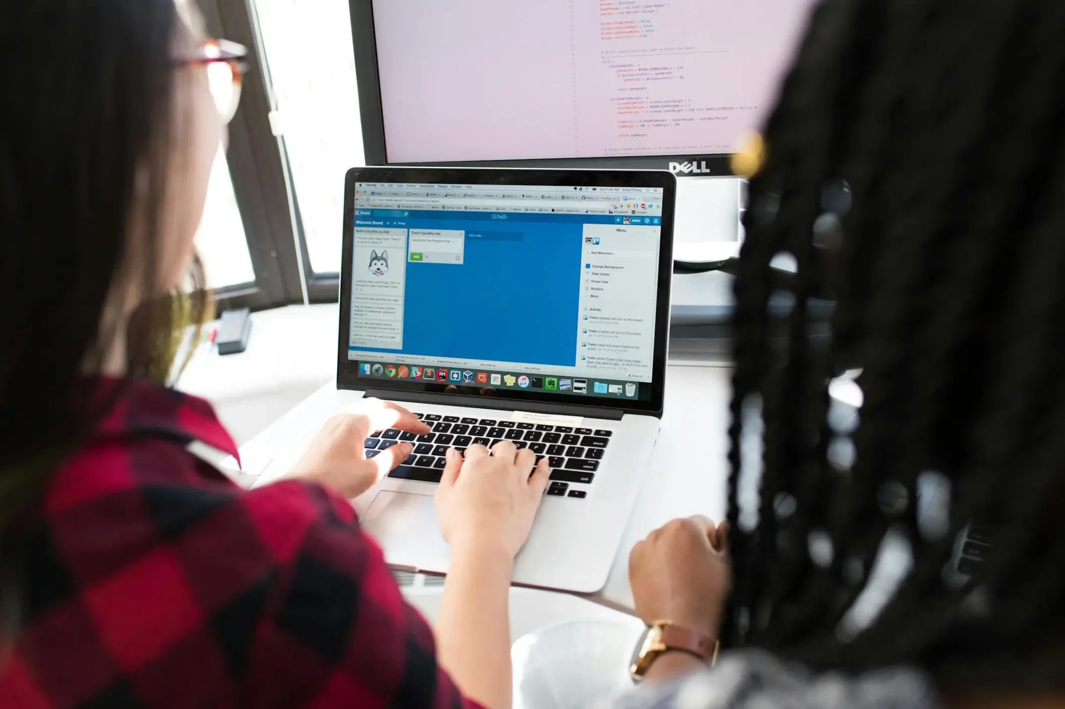 women working on laptop and pc together