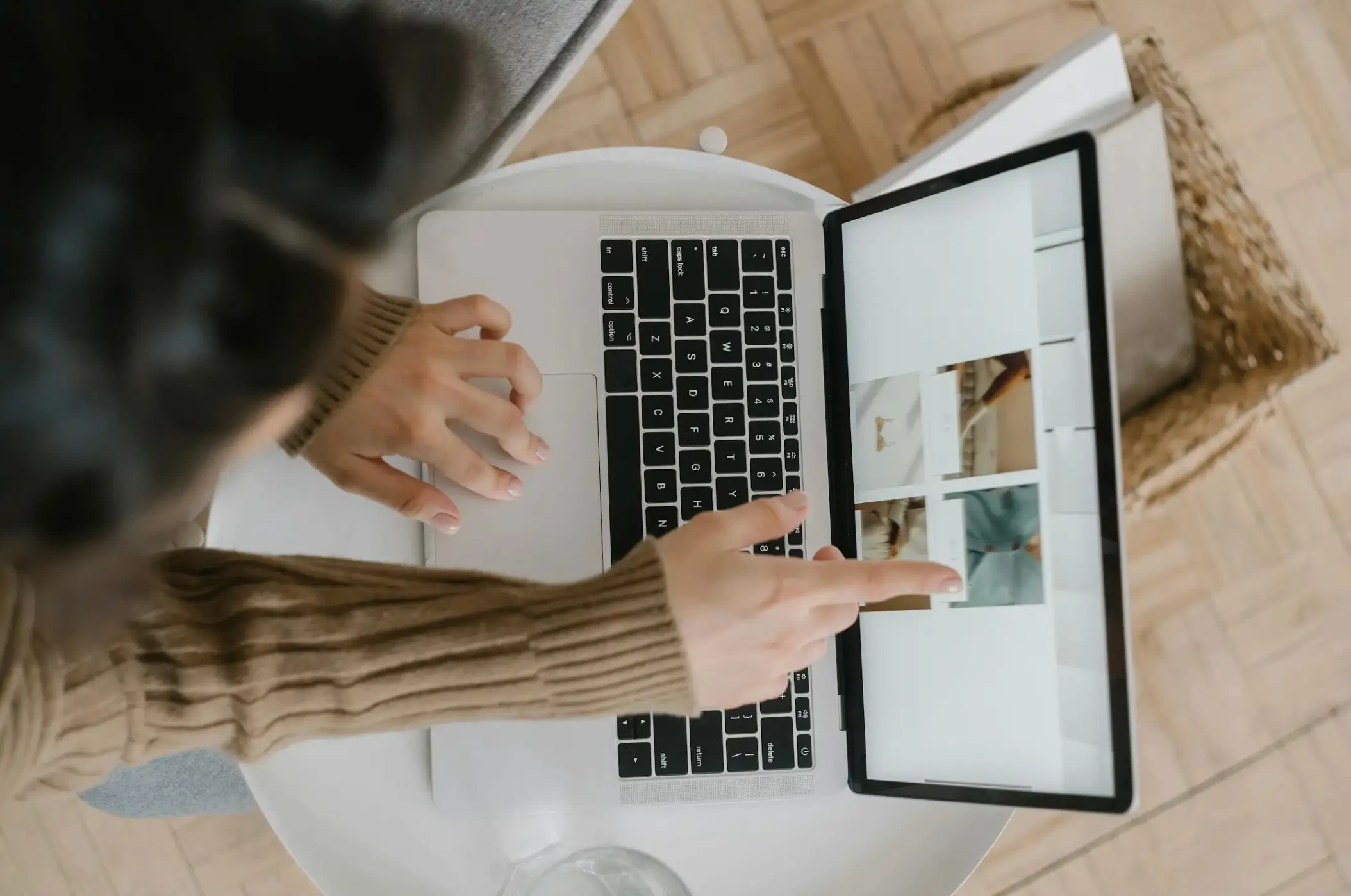 woman pointing at images on laptop
