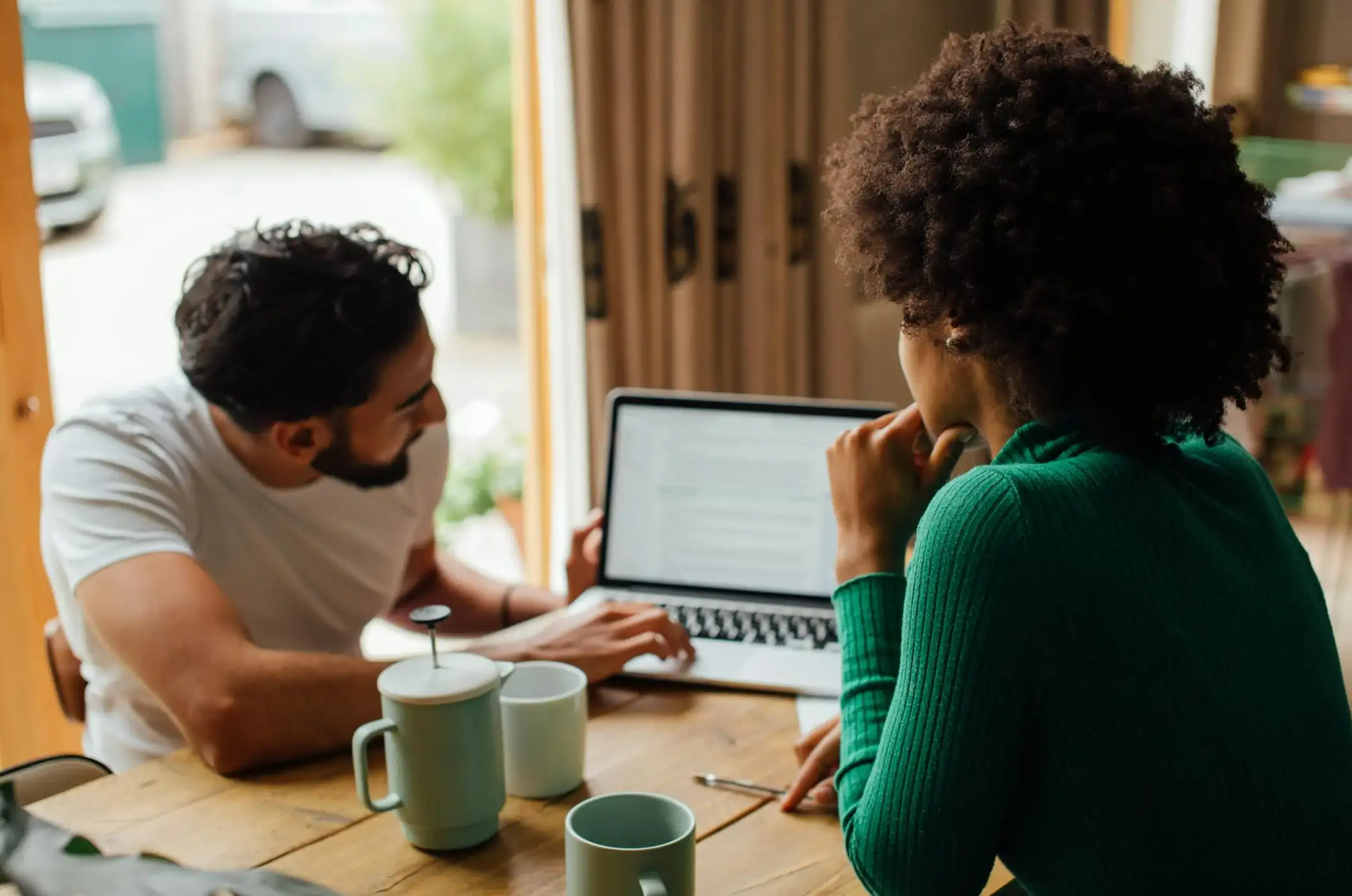 man and woman looking at laptop