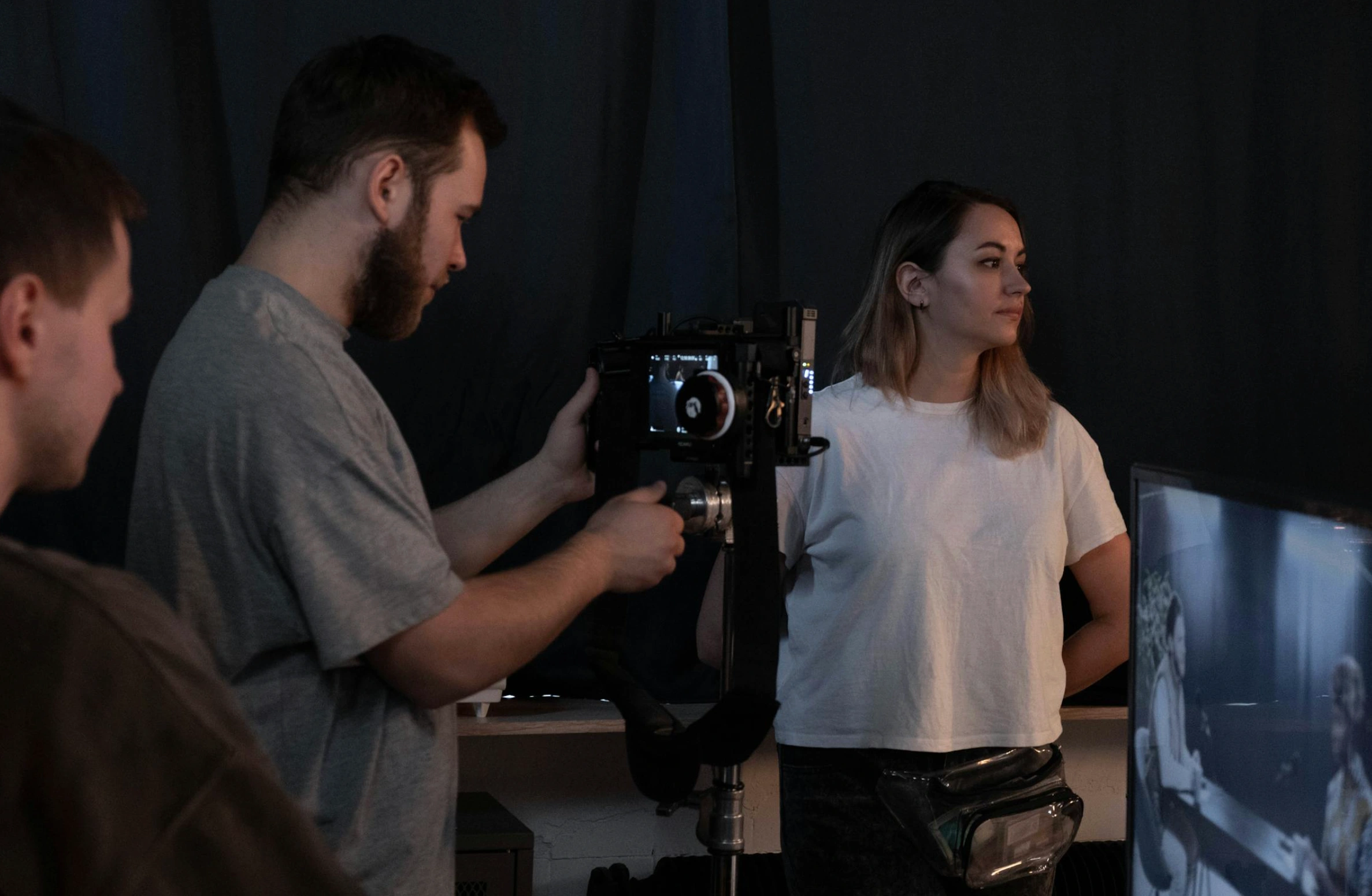 man videographing woman