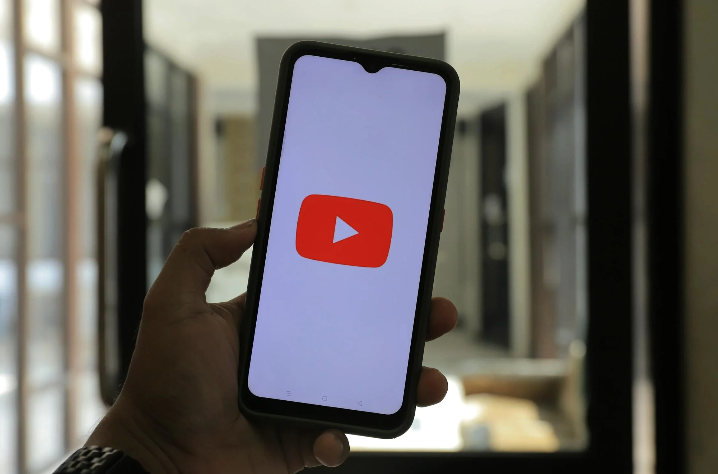 man holding phone on YouTube