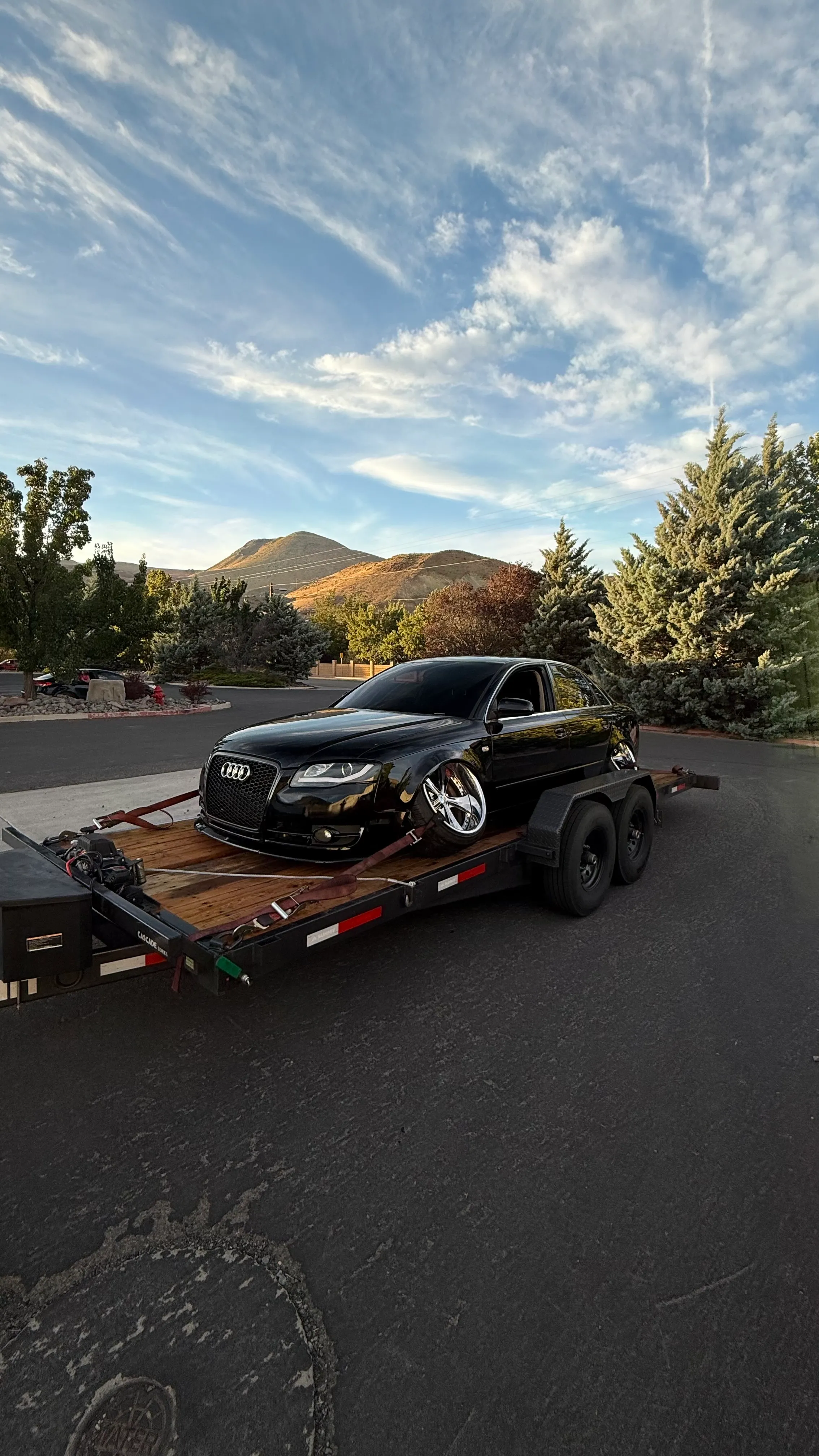 Gravity tilt car trailer hitched to a pickup at the OTG yard in Sparks