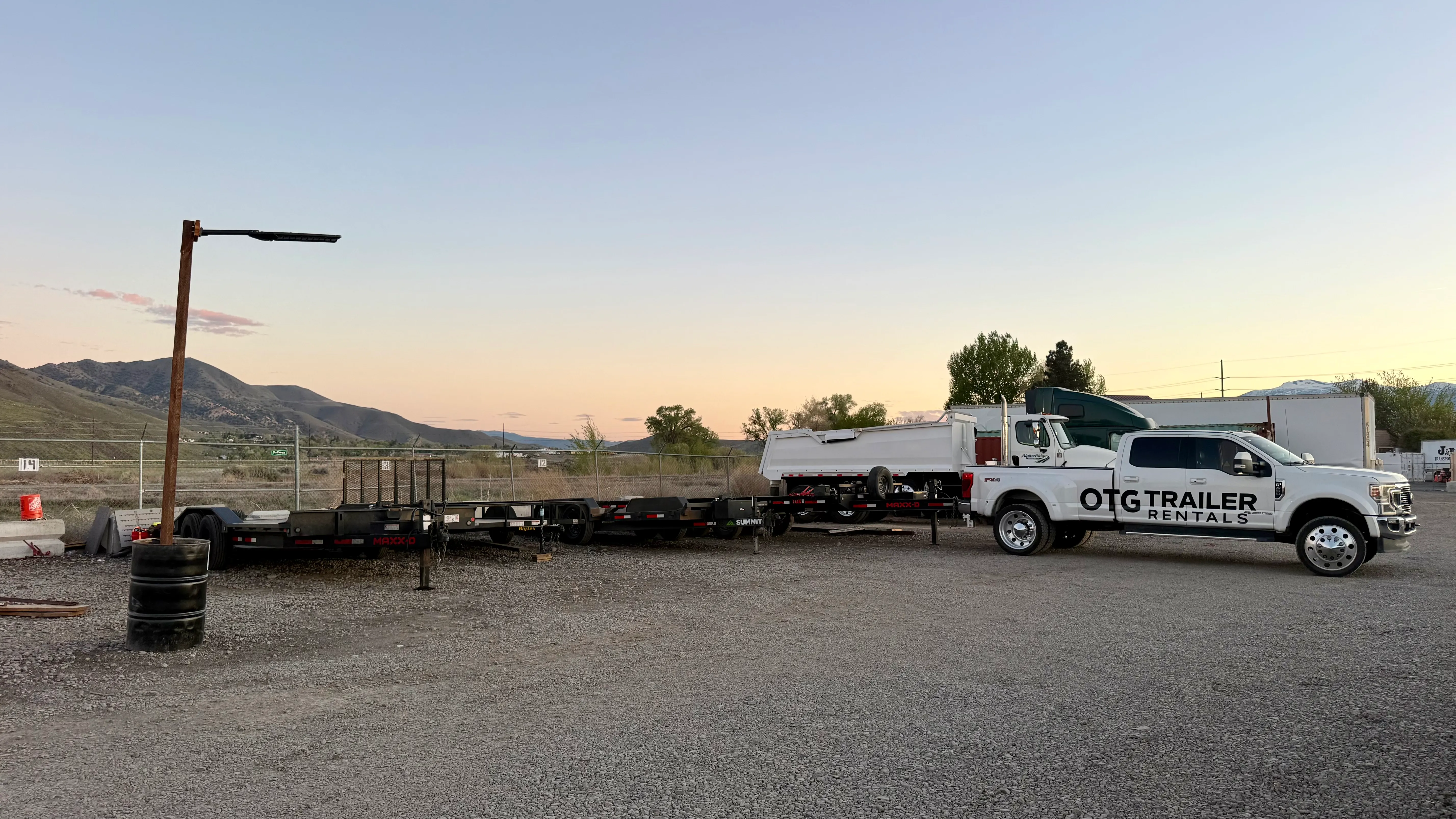 OTG Trailer Rentals truck and trailers at the Sparks lot at sunset