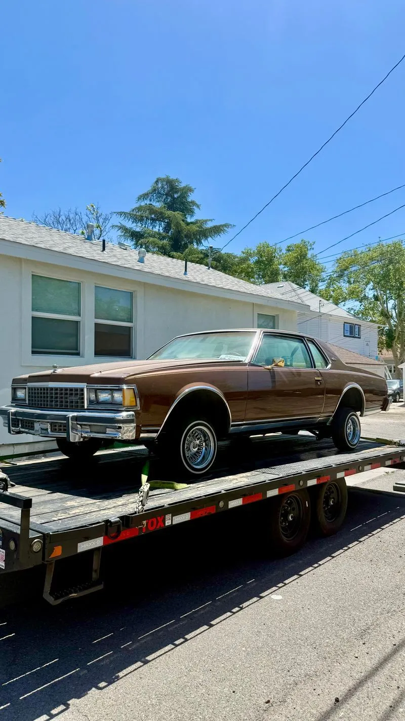 Classic brown Chevy Caprice strapped on an OTG car hauler