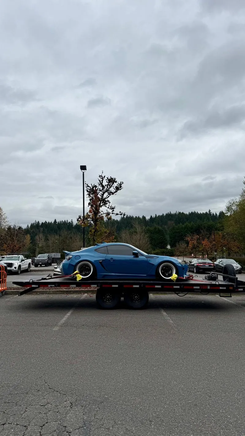 Widebody blue Scion FR-S strapped on the OTG deckover tilt trailer