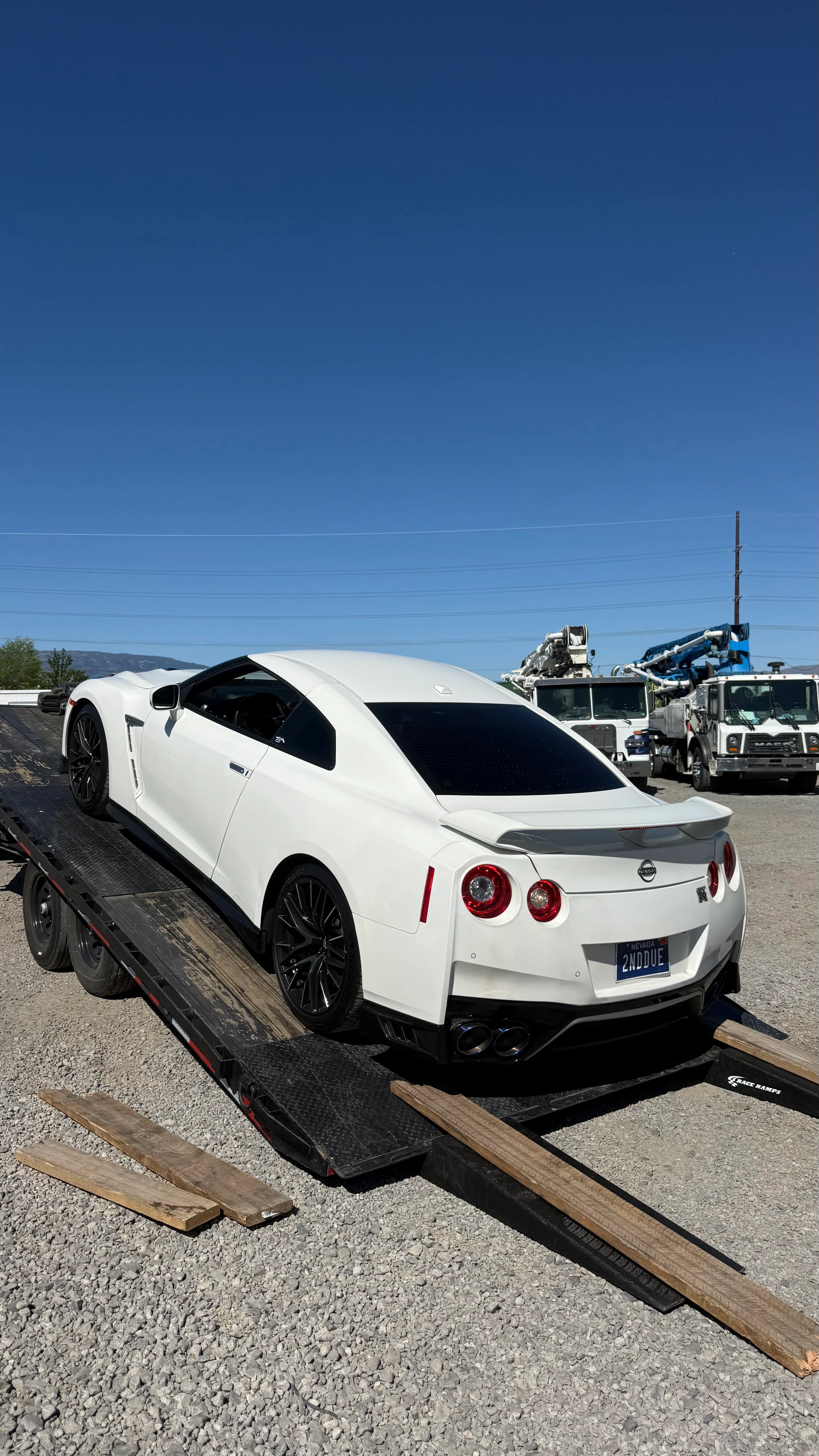 White Nissan GT-R loaded on an OTG car hauler