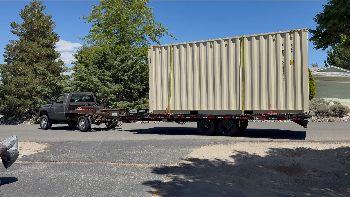 Shipping container on an OTG deckover trailer