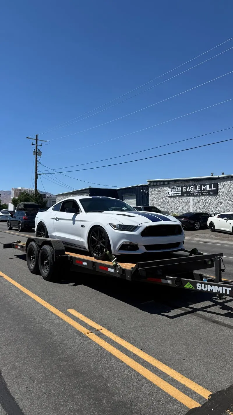 White Mustang loaded on an OTG Summit gravity tilt car hauler