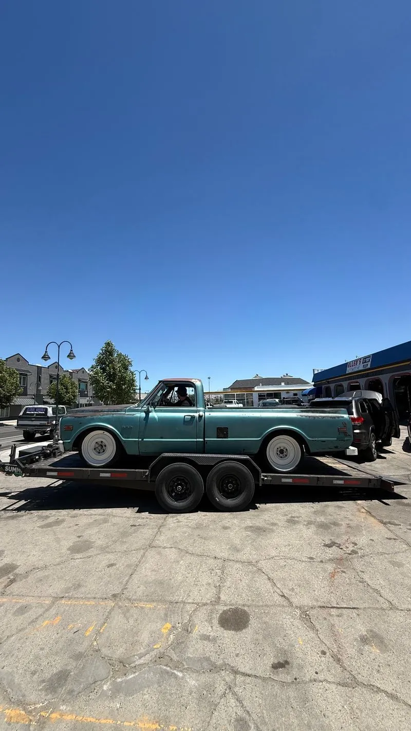 Classic teal Chevy C10 pickup on an OTG car hauler