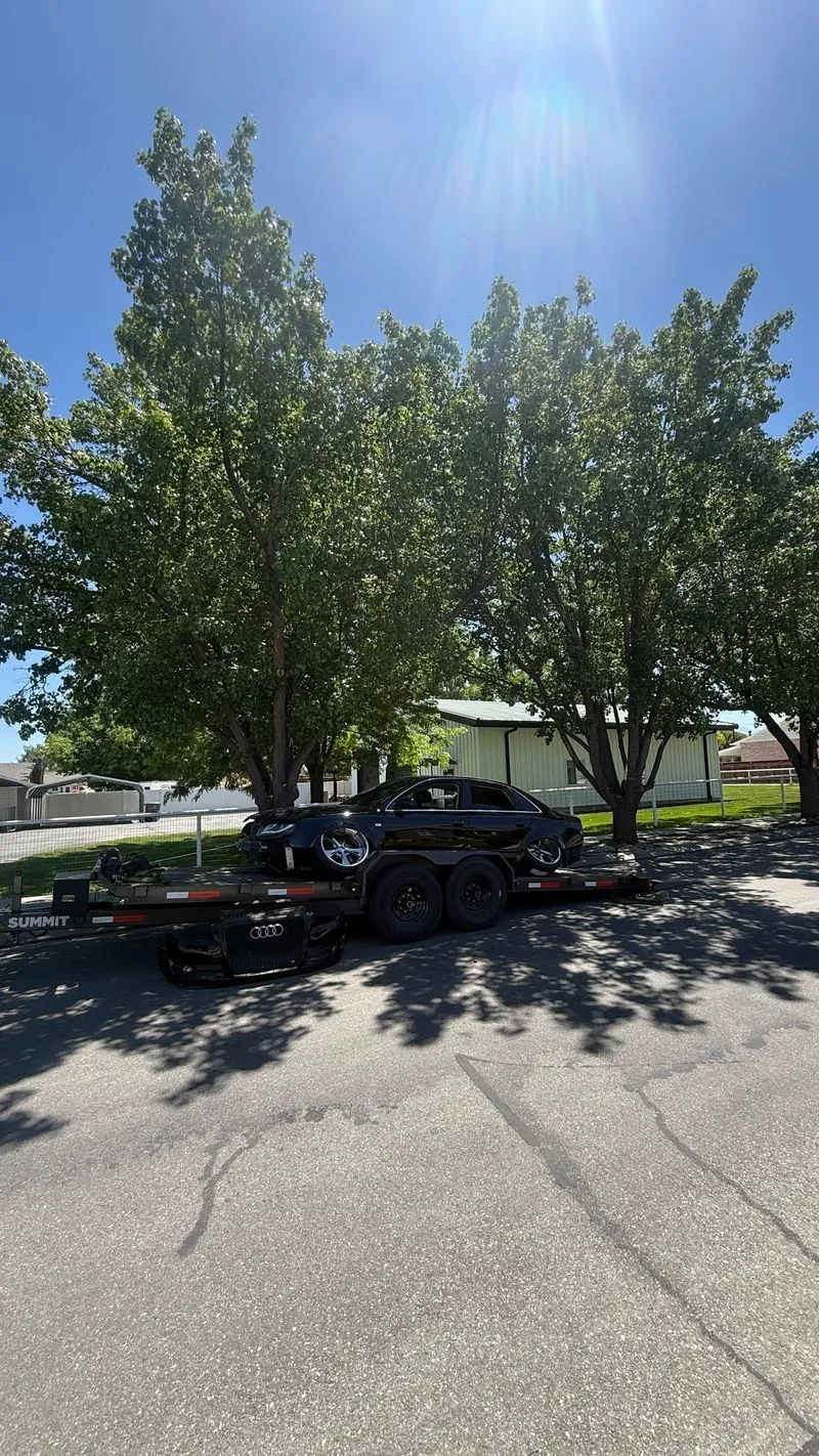 Cambered black Audi A4 on an OTG Summit gravity tilt car hauler