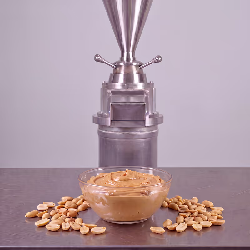 Cuatro frascos y un tazón con mantequillas de nuez, almendra y chocolate, con nueces y semillas alrededor.