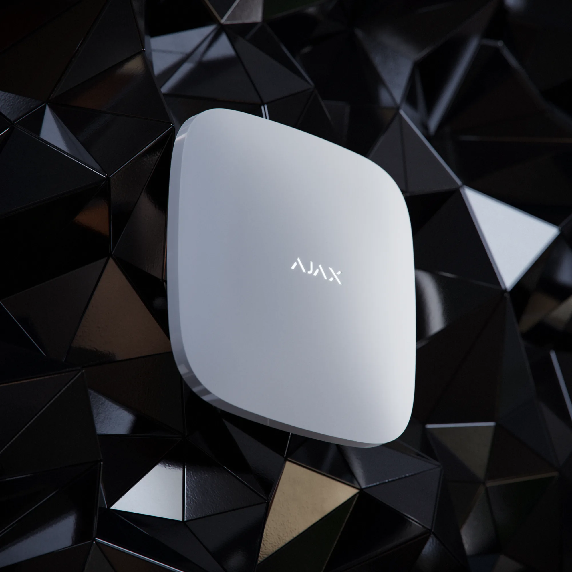 Ajax wireless alarm hub mounted on a black geometric wall