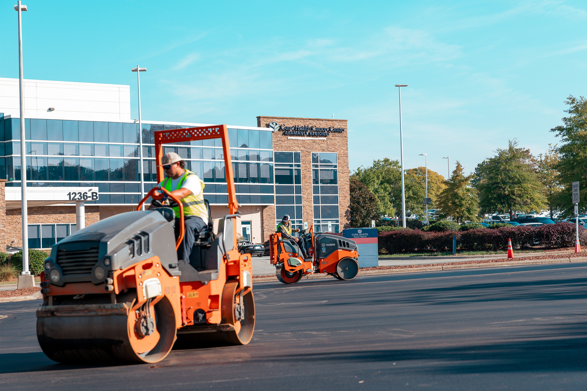 Lambeth Asphalt Services' team finishing the parking lot at Alamance Regional Medical Center with the HAMM roller compacting the asphalt.