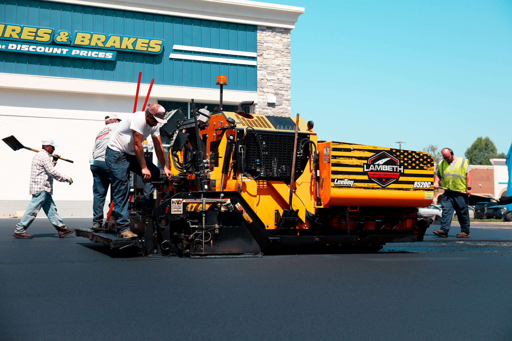 Lambeth Asphalt Services crew operating an asphalt paving machine