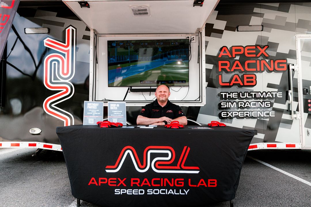 Apex Racing Lab reception area with branded racing simulator setup