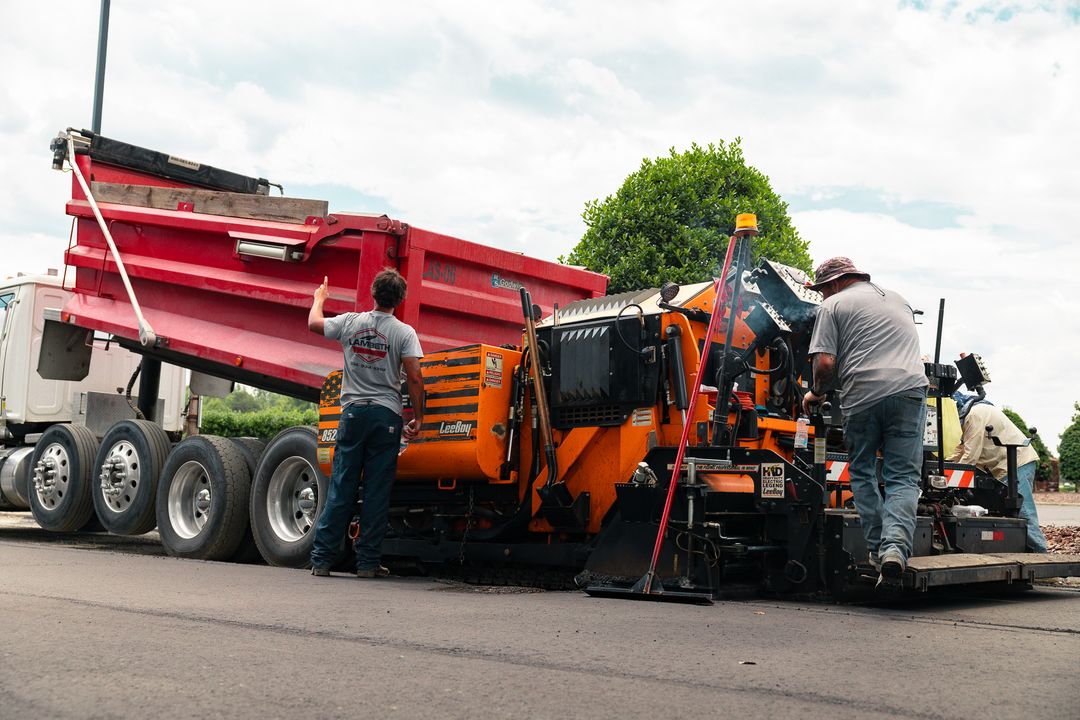 Worker maintaining Lambeth Asphalt Services paving equipment
