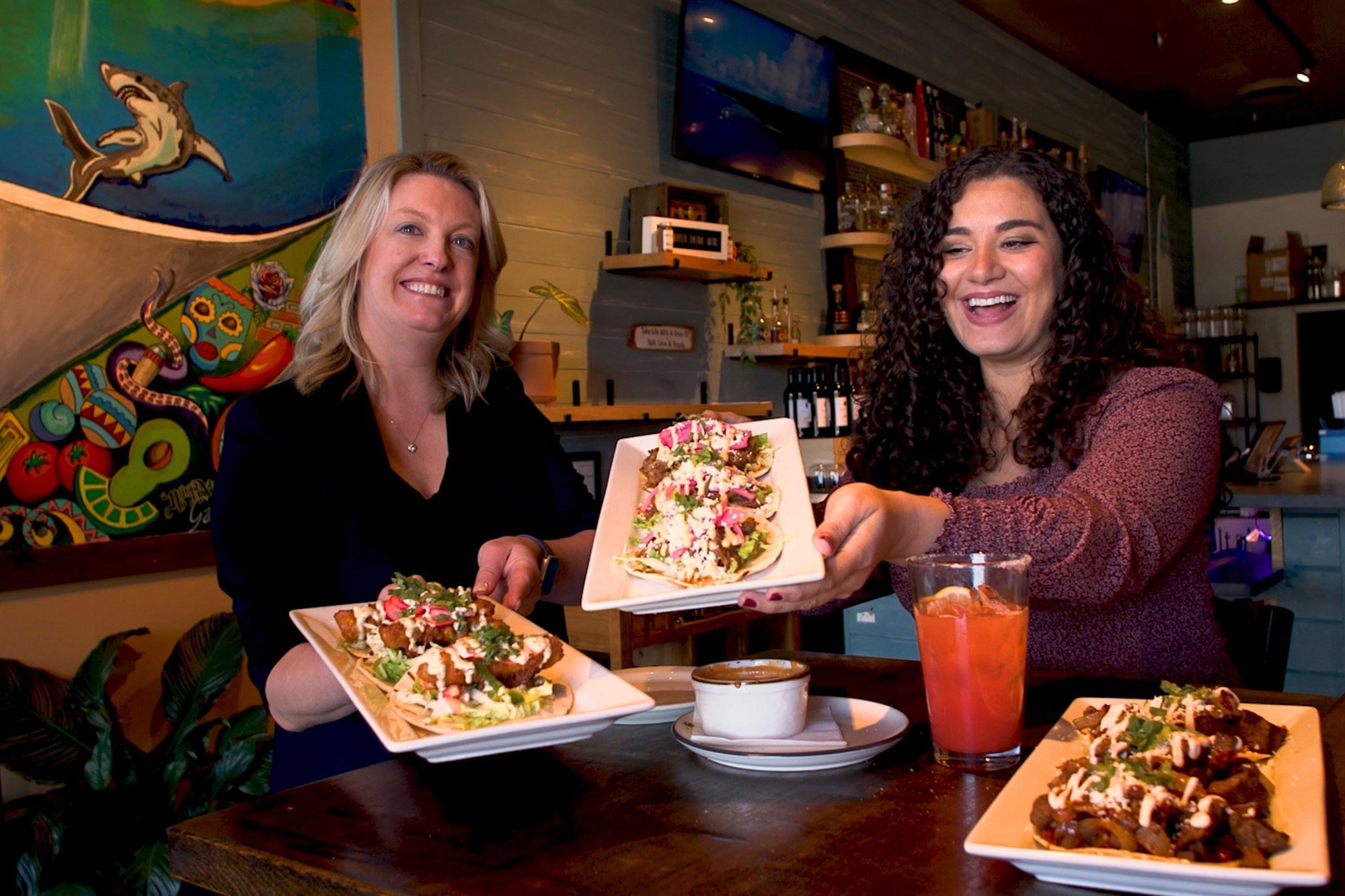 NC Eat & Play host Megan presenting tacos with a guest at Salt & Lime Cabo Grill in Raleigh NC