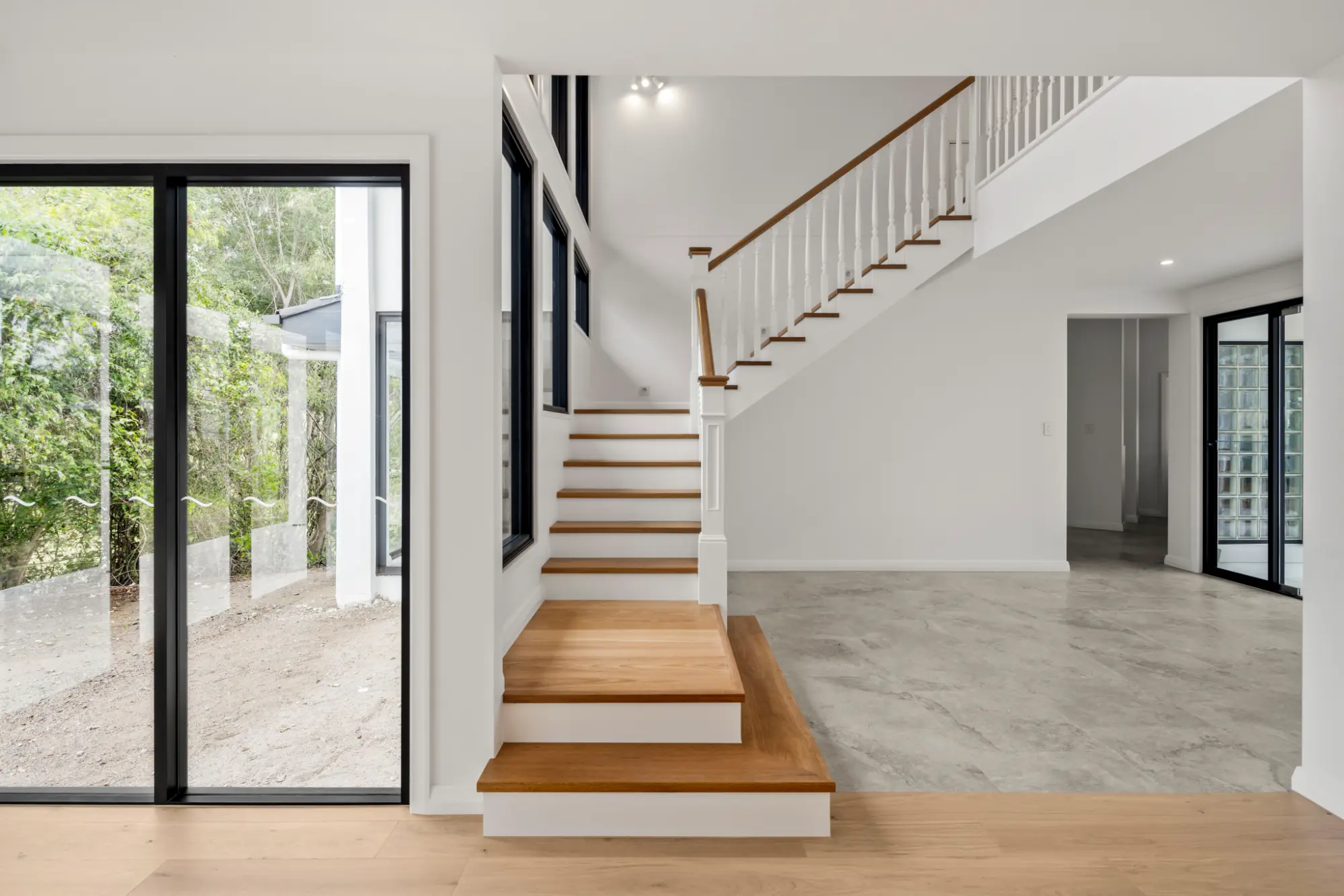 Modern staircase and open-plan interior in a high-end Brisbane residential project.