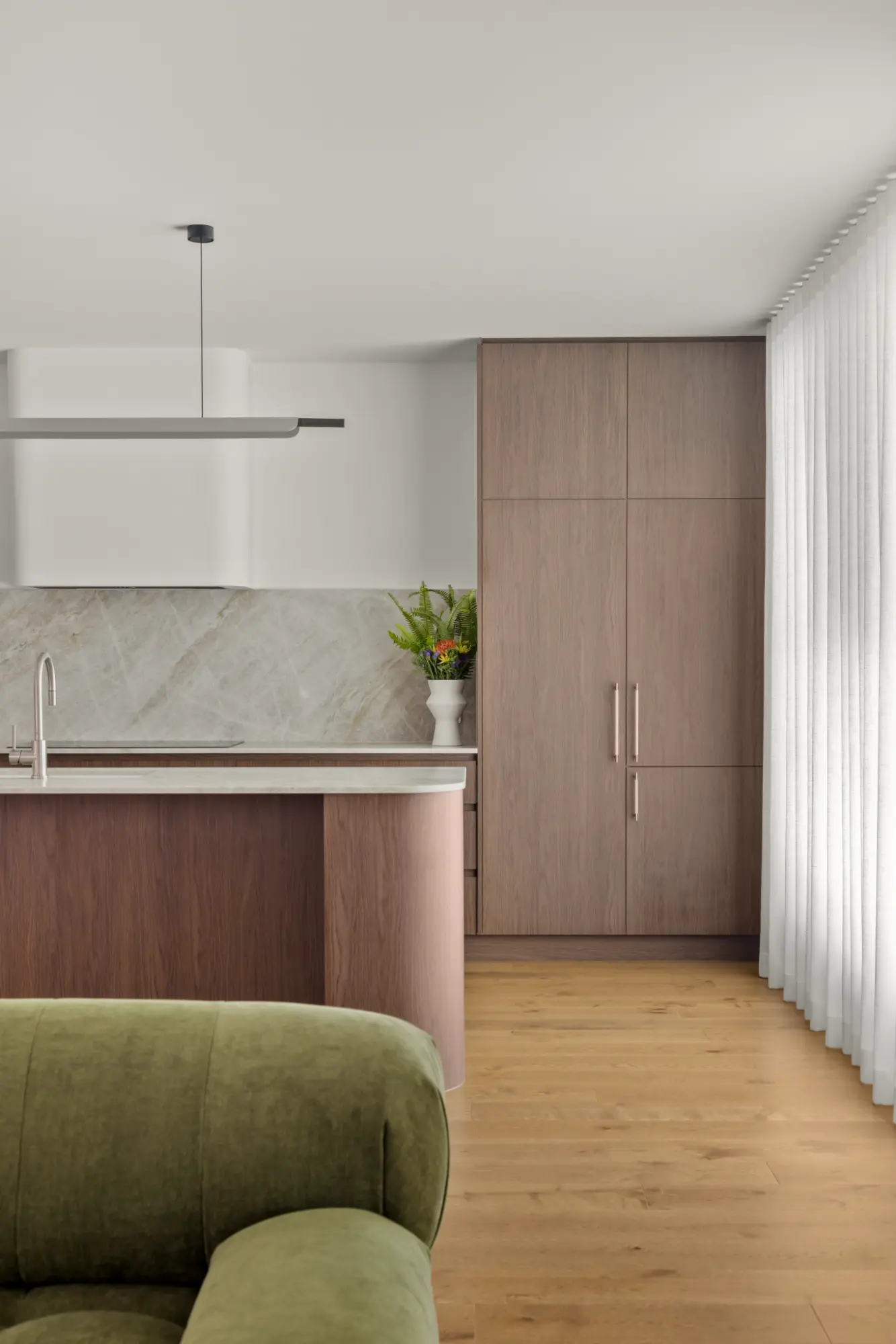 Modern kitchen with timber cabinetry, stone benchtops, and contemporary finishes in a high-end Brisbane residential project.
