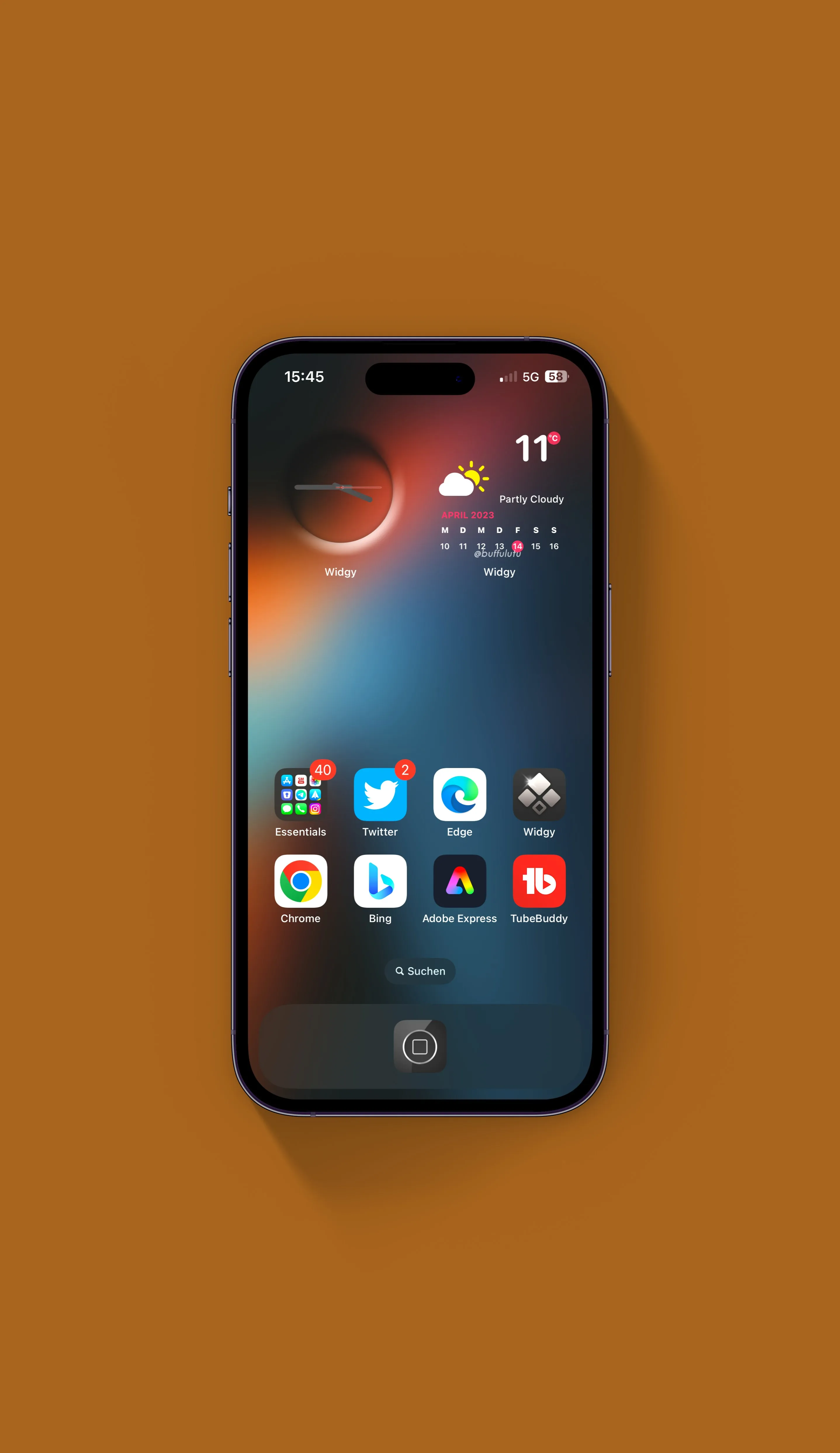 Smartphone displaying apps and widgets including weather, clock, Twitter, Chrome, and Bing on a brown surface.