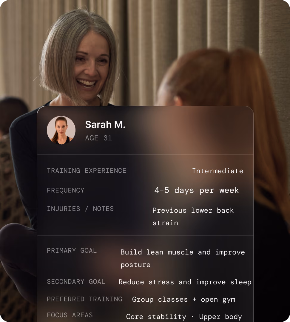 Two women in conversation during a one-on-one fitness planning session.