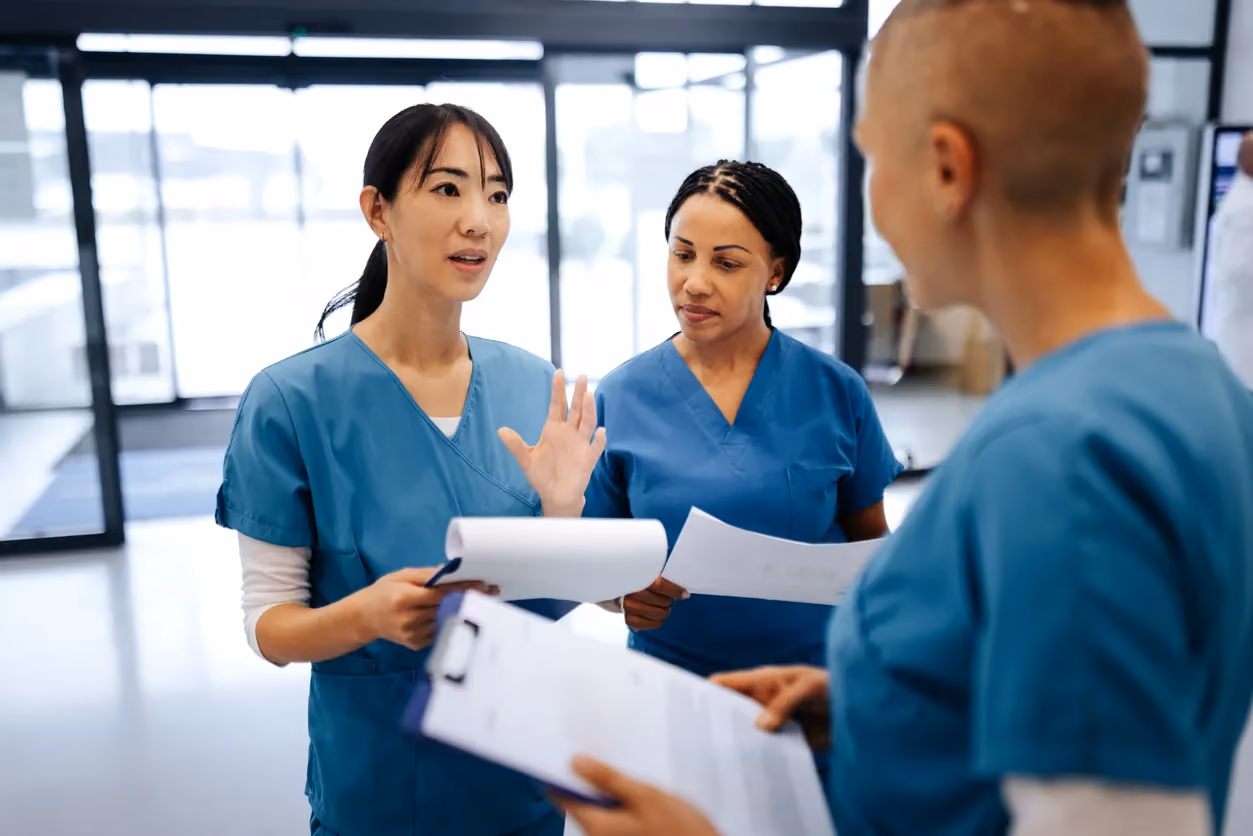 three vets discuss treatment in veterinary reception
